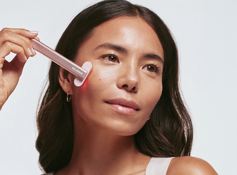 Person using a Solawave 4-in-1 Advanced Skincare Wand on their face