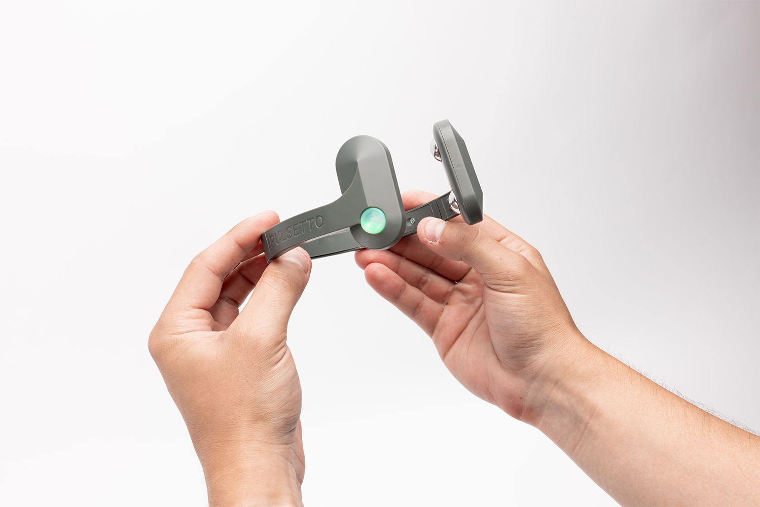 Person holding a Pulsetto device in their hands