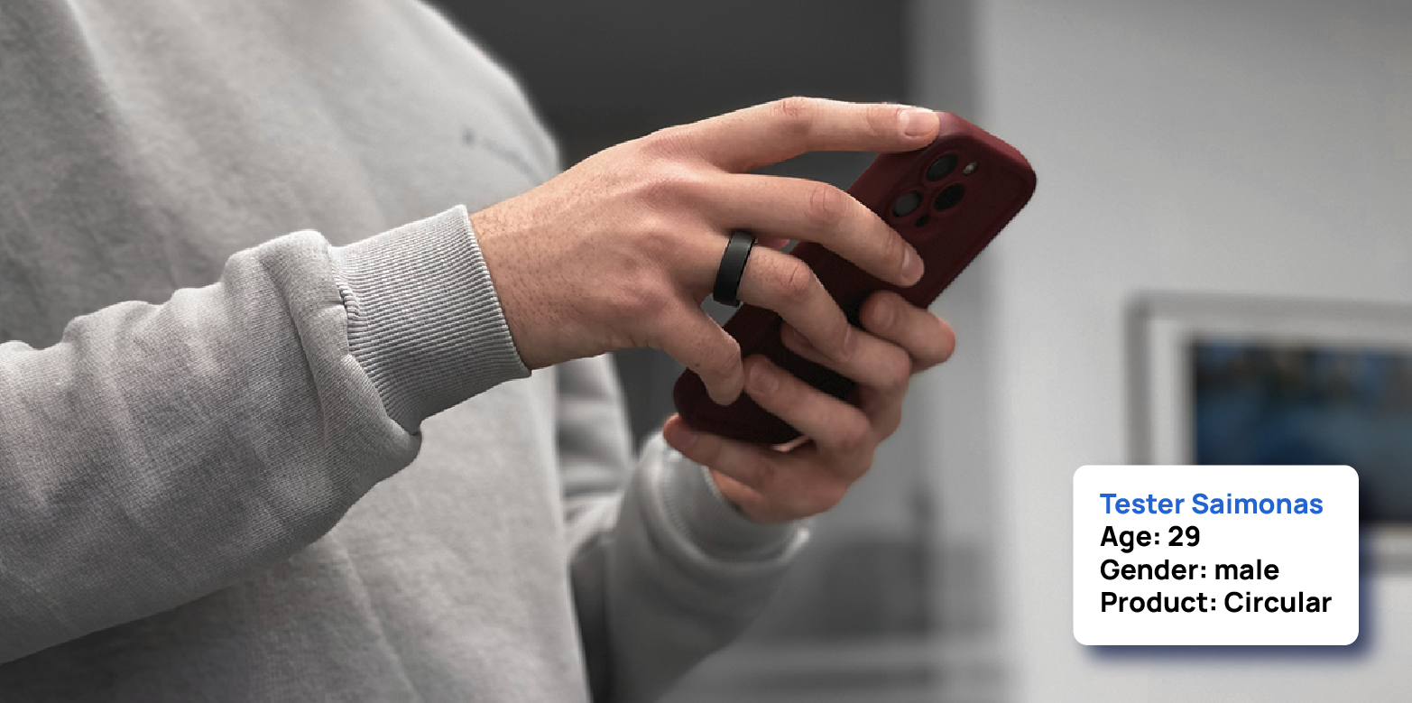 User wearing circular smart ring and using the phone