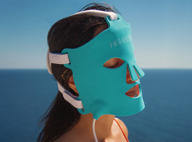 Person using a Higherdose Red Light Face Mask outside