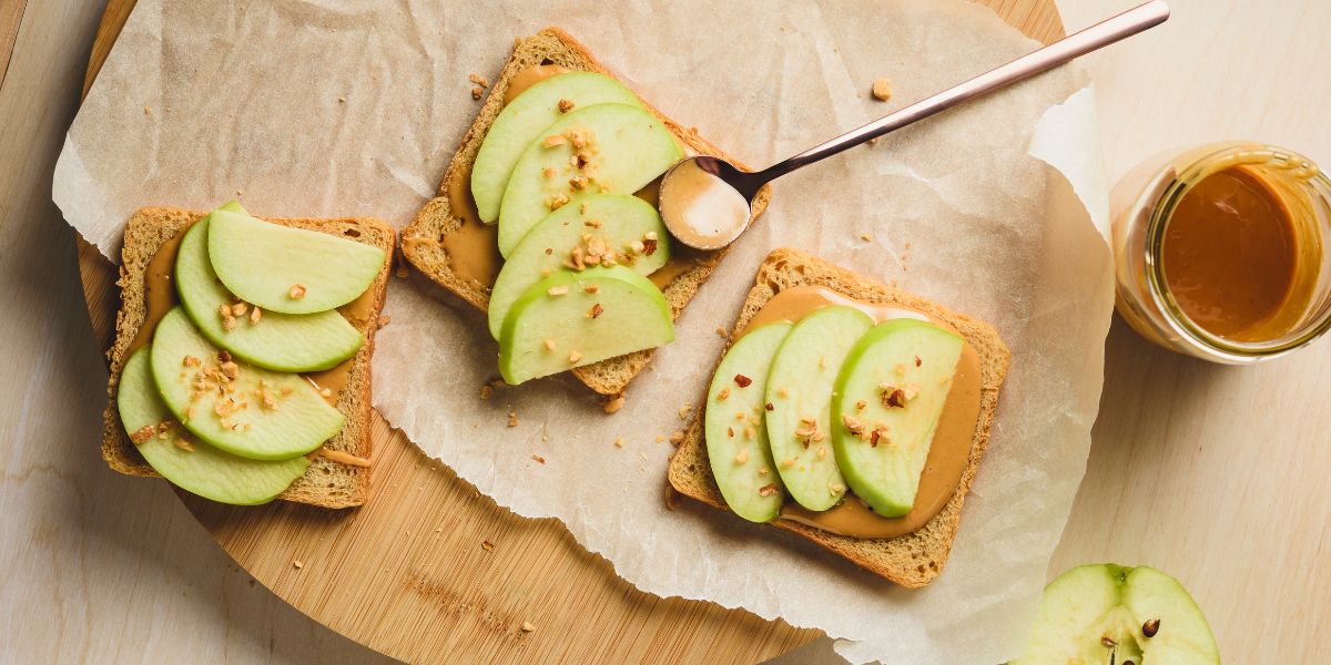 Three sandwiches with peanut butter and apple slices