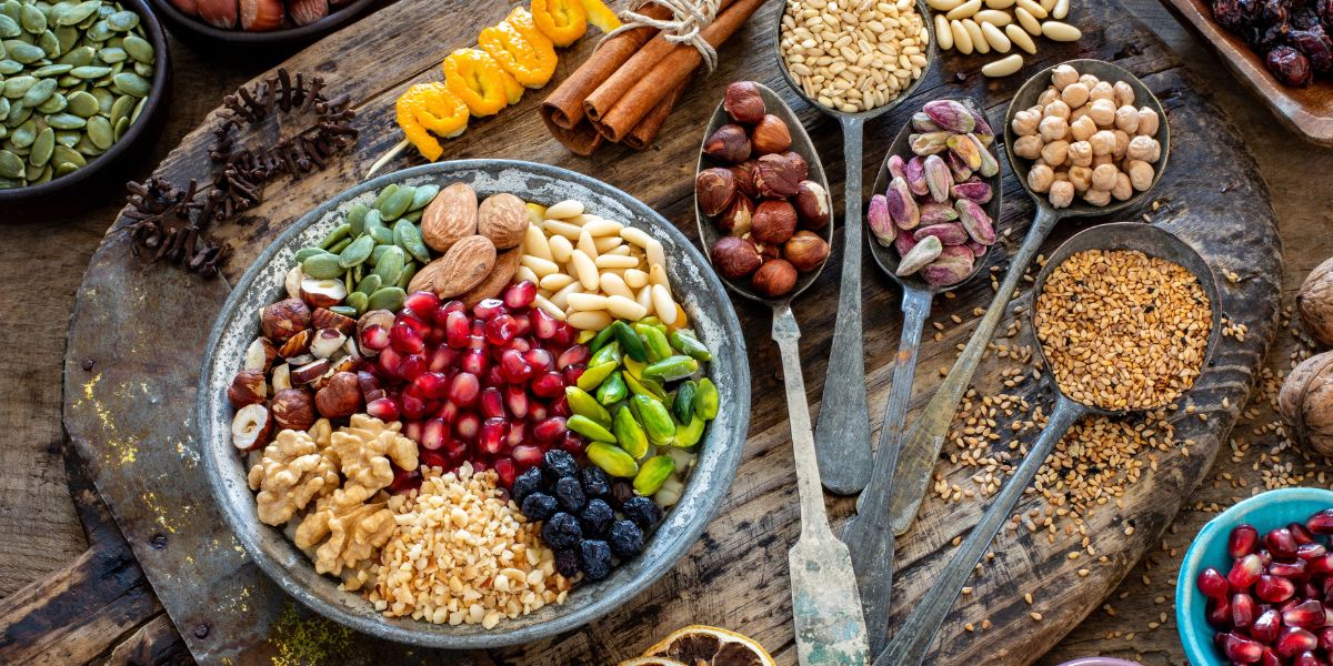 Different legumes and nuts on a wooden table