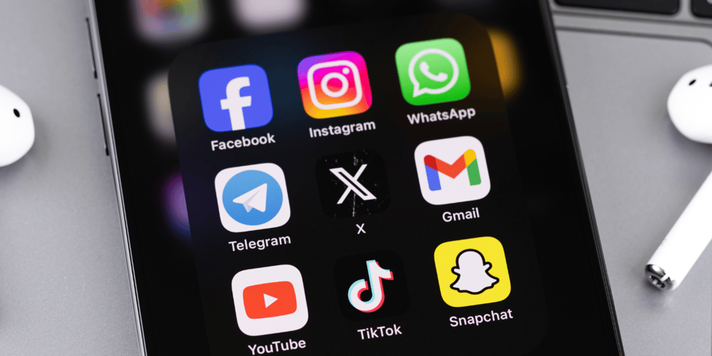 Smartphone with mobile apps closeup, Facebook, Instagram, WhatsApp, Twitter X.
