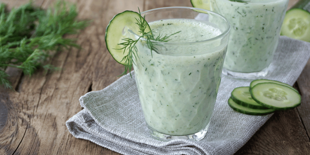 Smoothies from kefir, dill and cucumbers on the table.