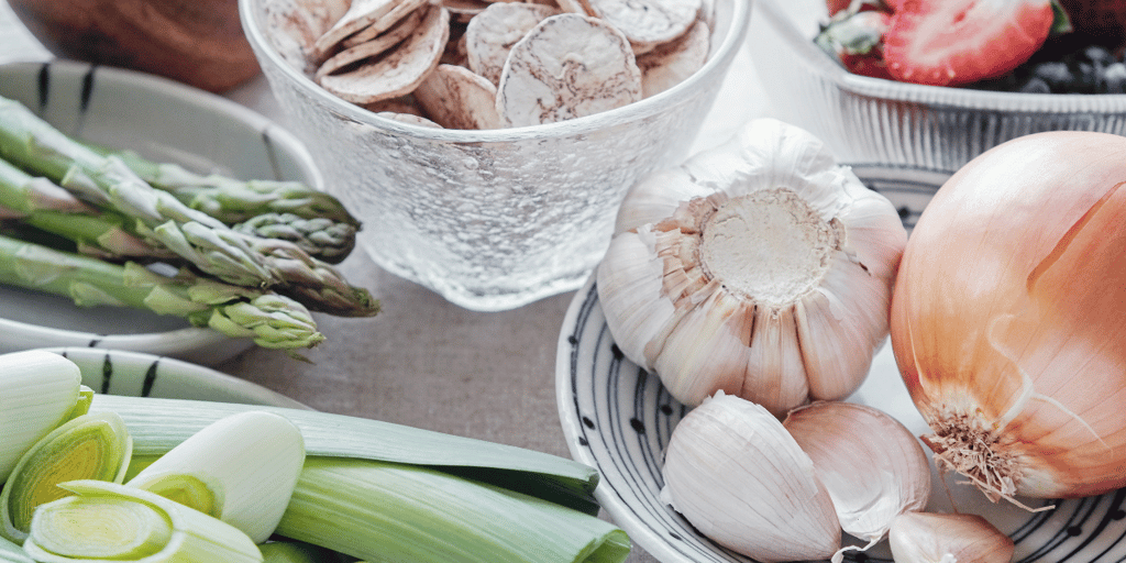Garlic, onion, asparagus and other prebiotic-rich foods on the table.