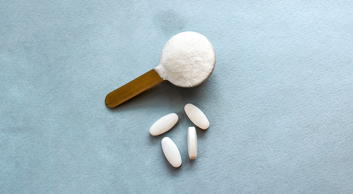 Scoop of marine collagen powder, set against a grey background