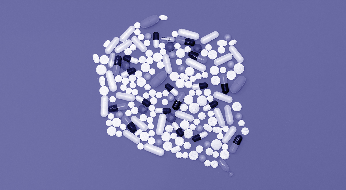 Dozens of pills on a violet background.