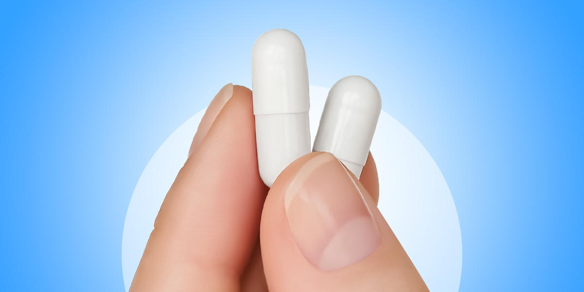 Fingers holding Prebiotics and Probiotics