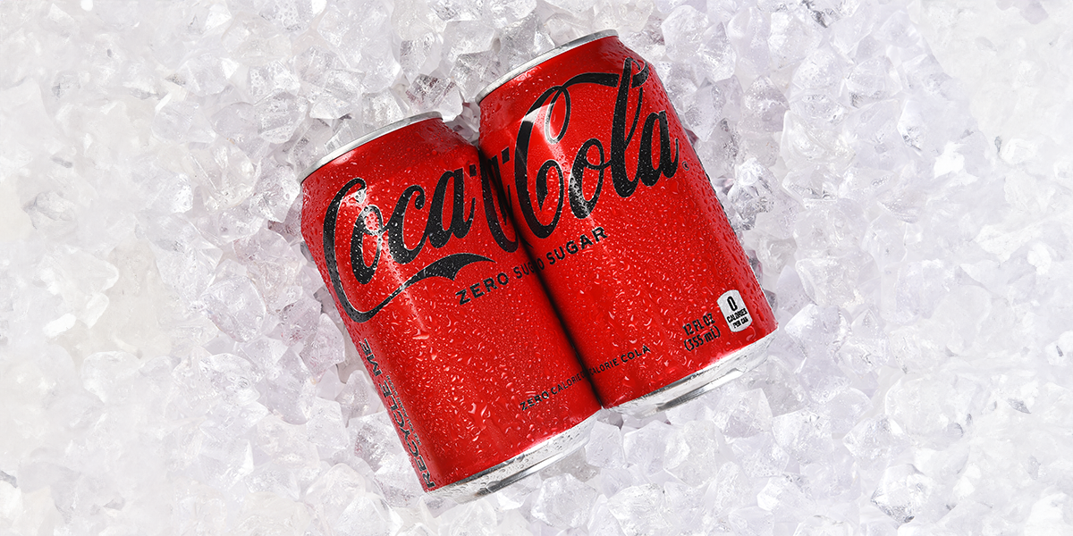 Two Coca Cola cans on ice