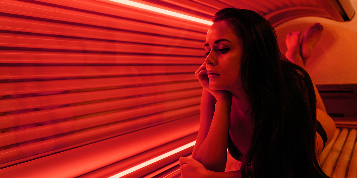 Person on a tanning bed with red light