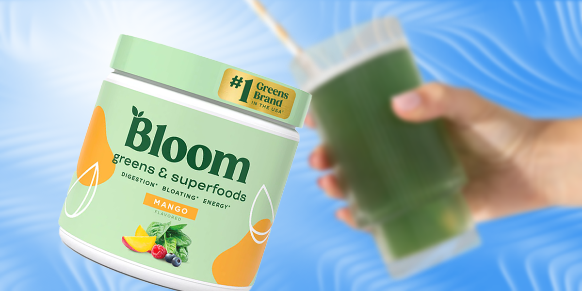 A bottle of Bloom Greens & Superfoods supplement and a hand holding a green smoothie