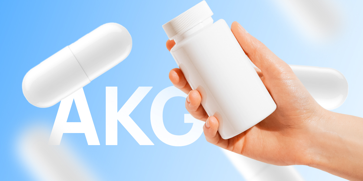 Hand holding white AKG pill bottle in blue background