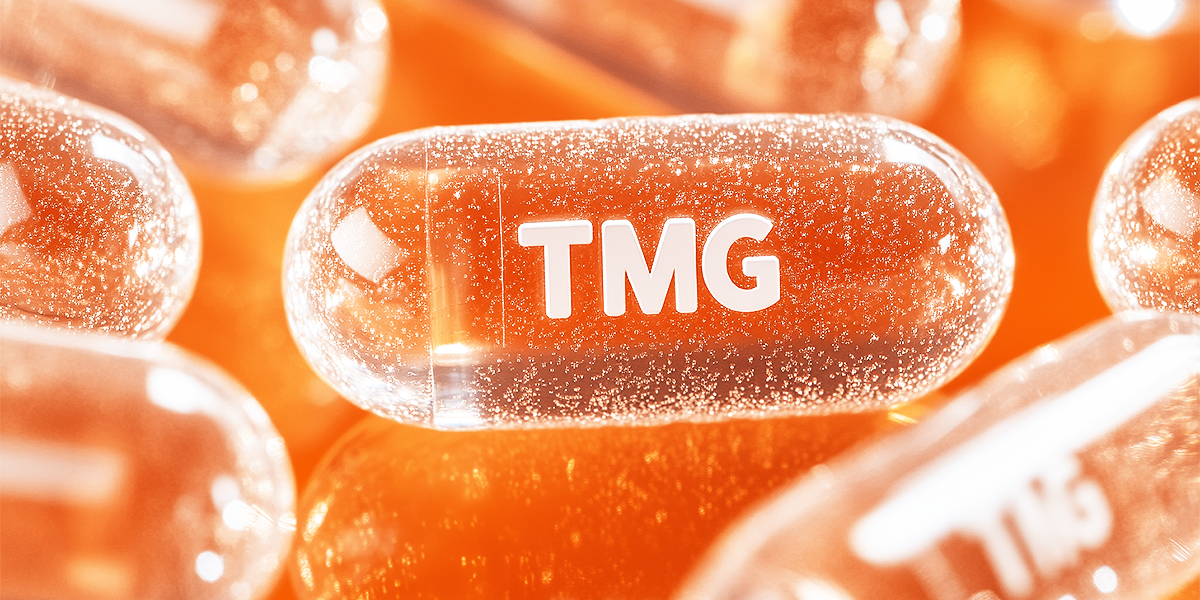 Illustrated close-up of an orange TMG pill set against an orange background