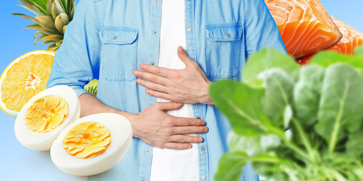 Torso feeling their stomach with variety of foods around them: eggs, pineapple, salmon