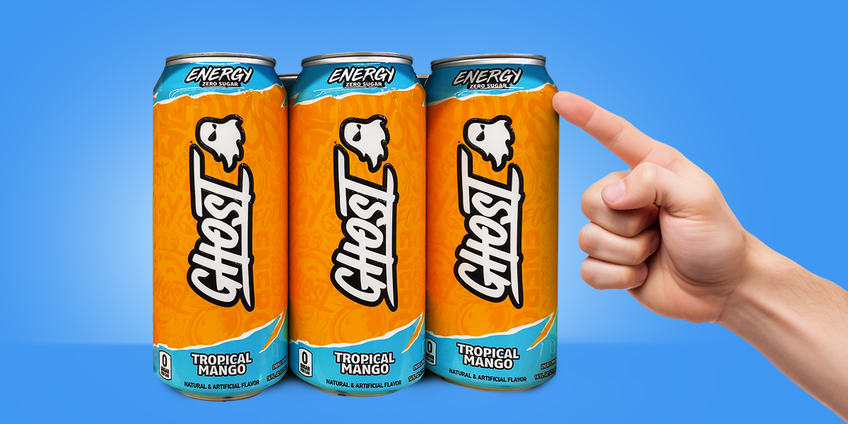 Hand pointing to orange cans of Ghost energy drink on blue background