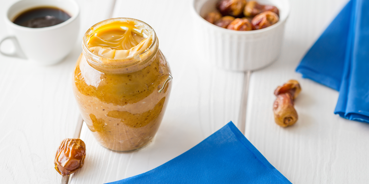 Date caramel recipe on a table set on a blue and white table