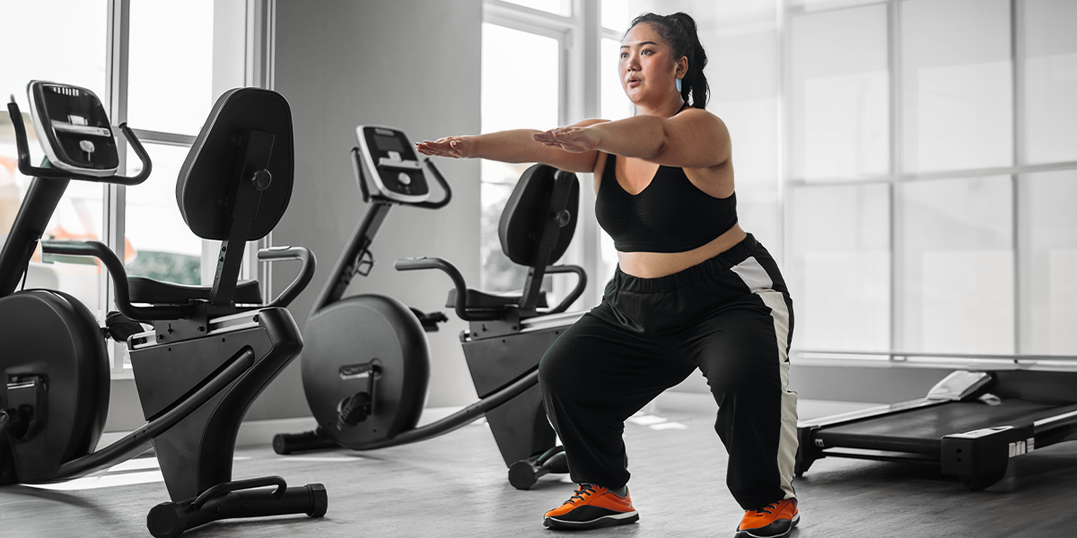 Person in the gym working out near sports equipment