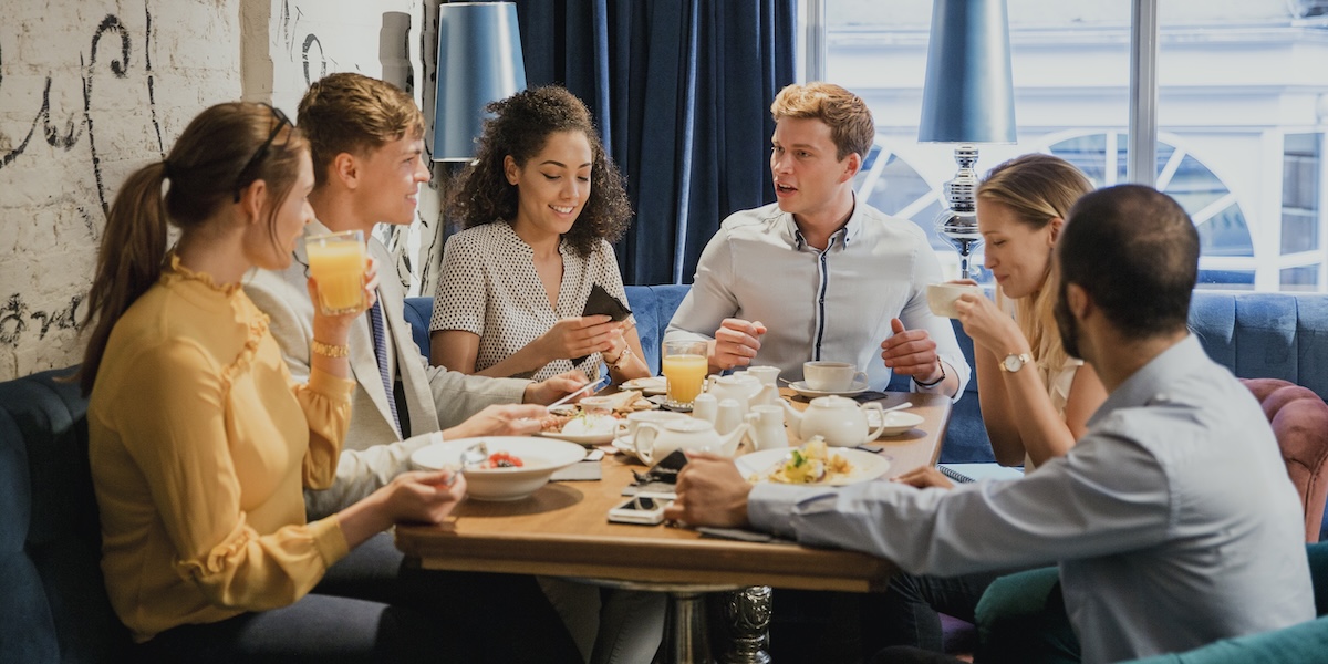 A group of friends sharing a meal around a table