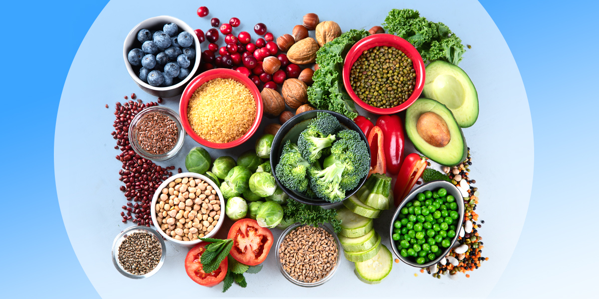 Different types of fiber, including broccoli, seeds and nuts, set against a blue background
