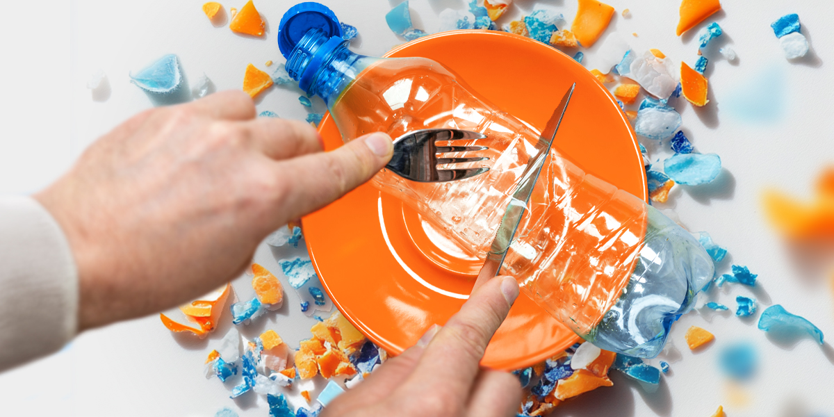 Person cutting a plastic bottle with a fork and a knife