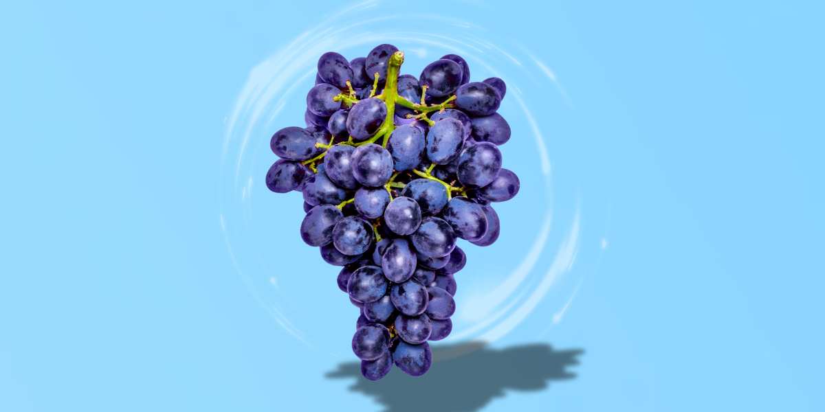 Purple grapes floating on a light blue background