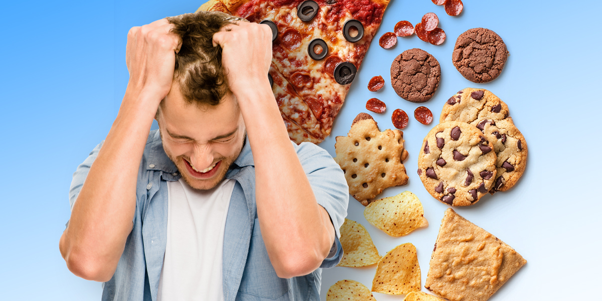 A stressed person surrounded by junk food