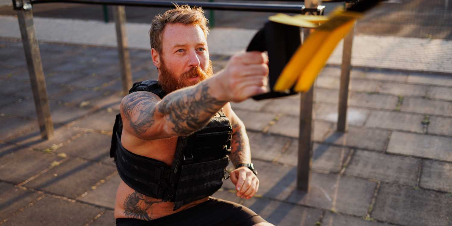 man working out with a weighted vest outside
