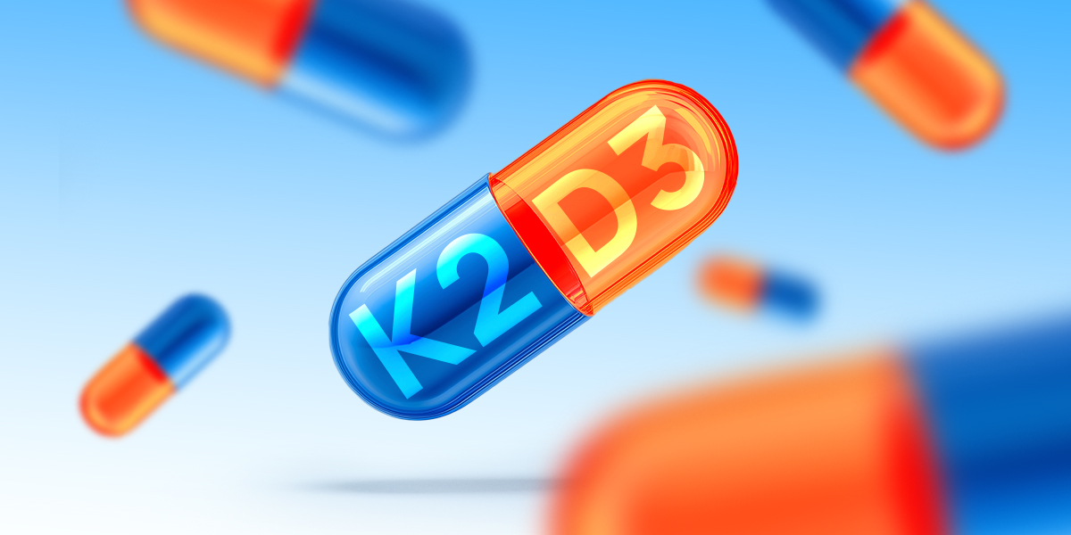 Illustration of a split pill in two: vitamin K2 and D