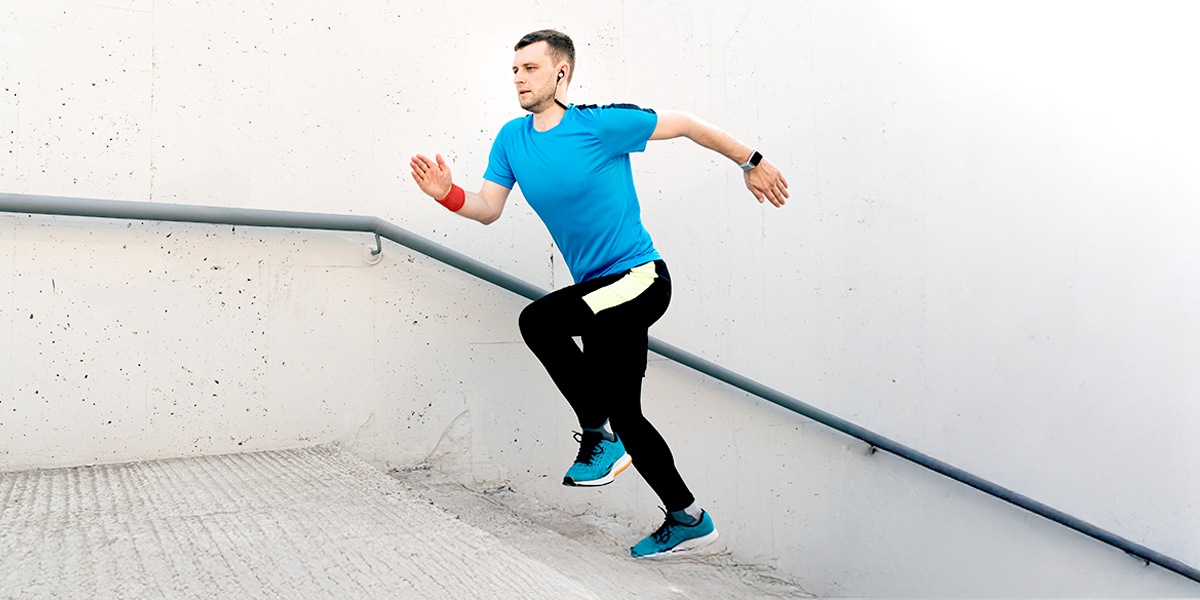 Person running up the stairs trying to build muscle