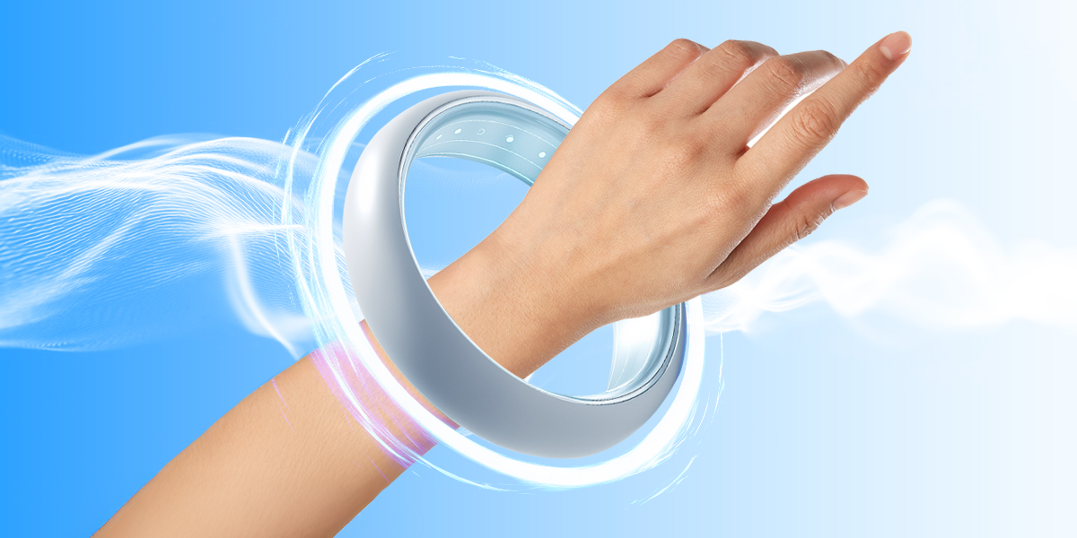 Persons hand wearing a pemf device in blue background