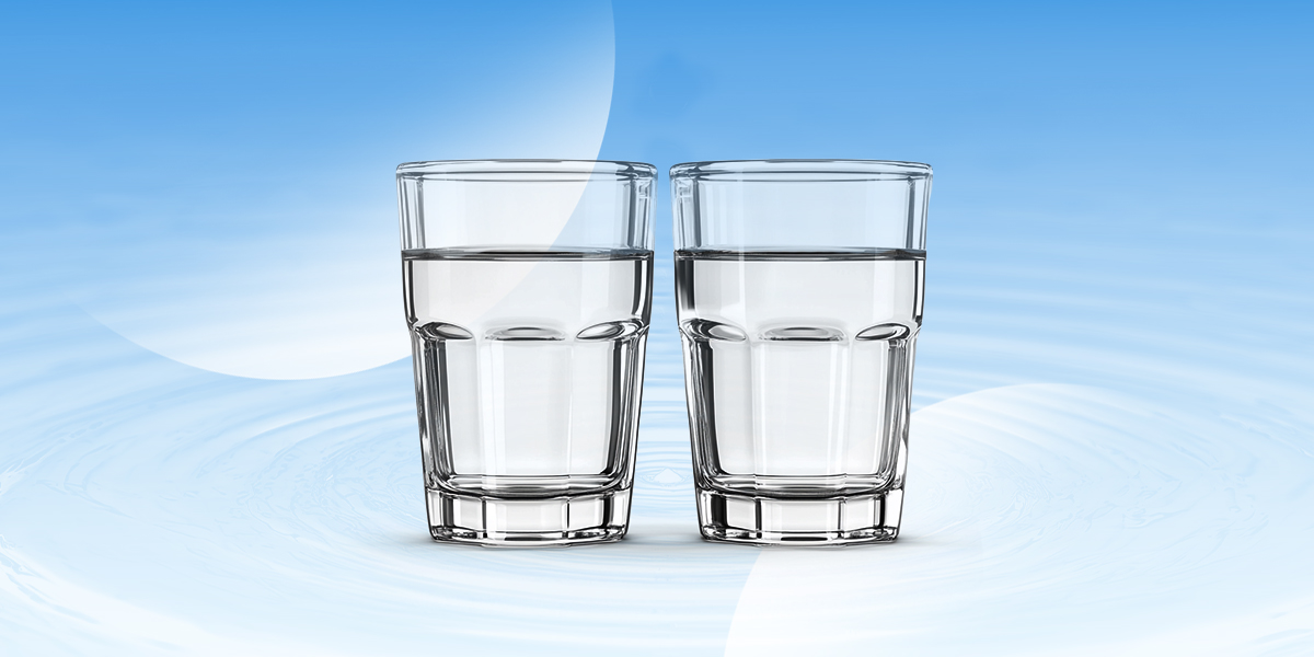 Two glasses of water in blue background
