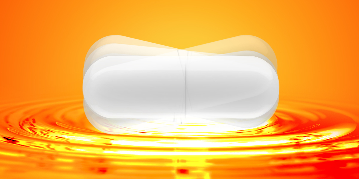 A white large capsule in motion on an orange background