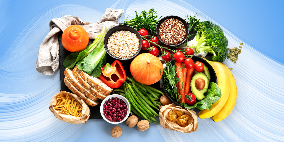 High-fiber foods such as fruits, vegetables, seeds, and whole grains on a black board