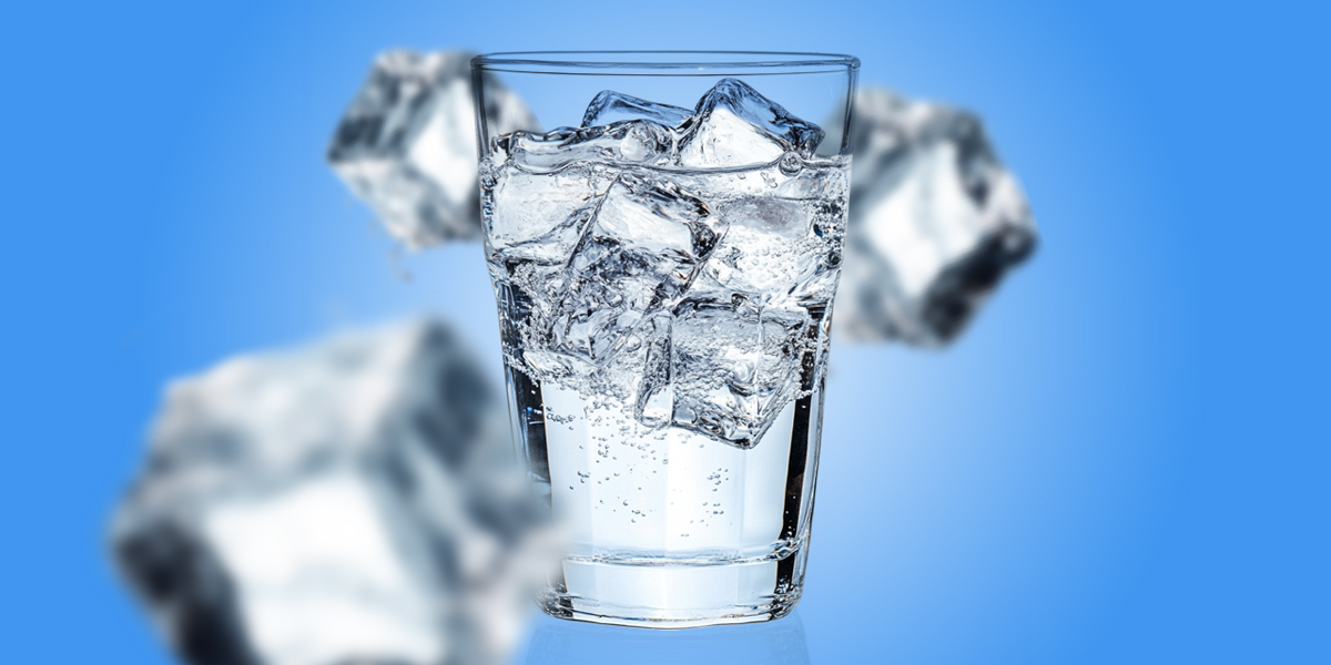 Glass of ice water in blue background