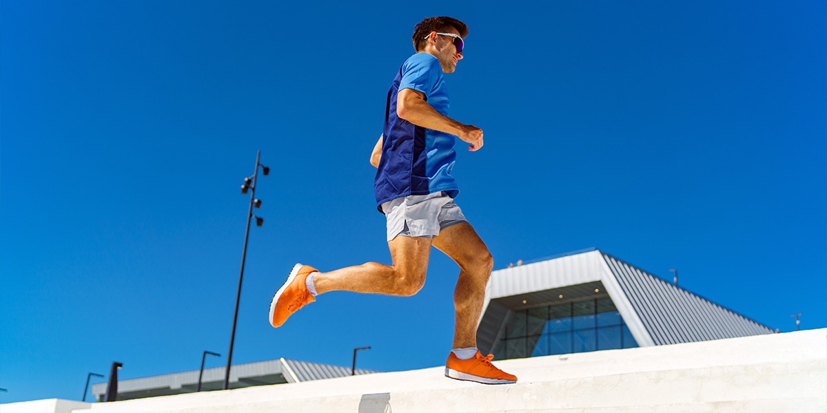 Person running outside sunny day blue background