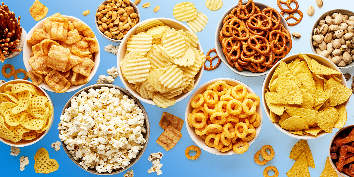 Various snacks in bowls blue background