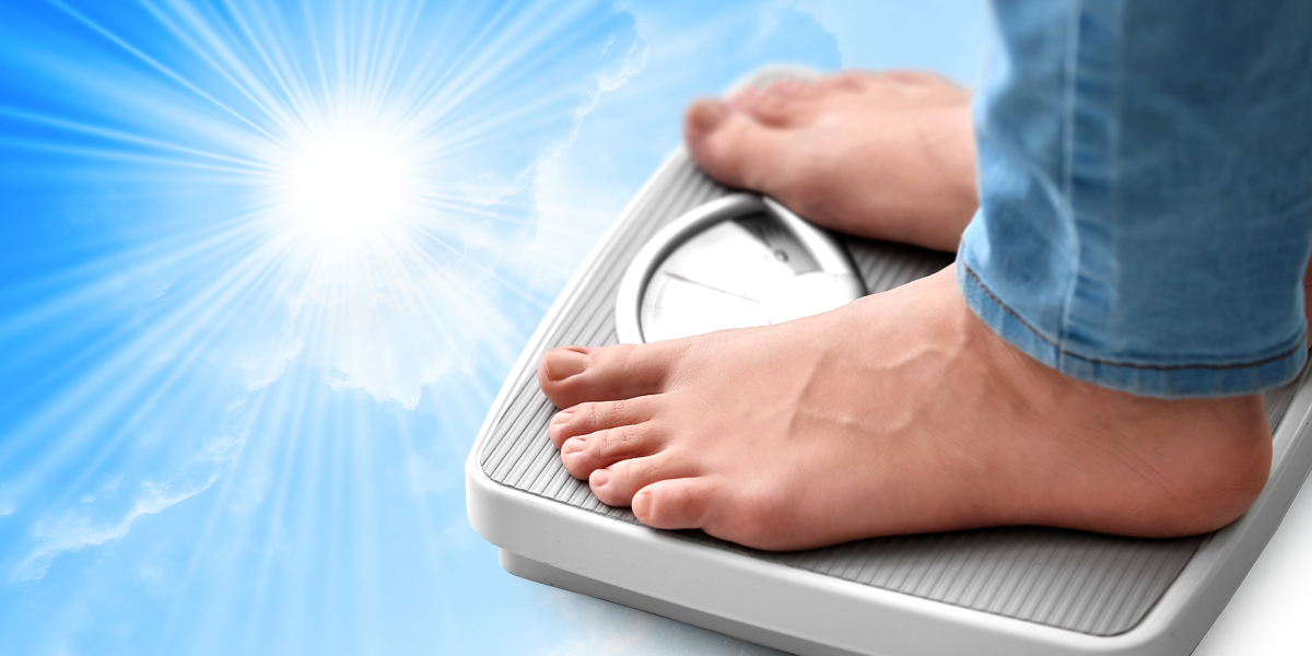 Feet measuring their weight on a scale in blue background