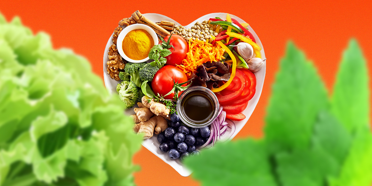 mix of vegetables, fruits, grain, nuts, herbs in a heart shape