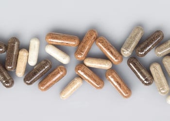 Spermidine supplements set against a grey background