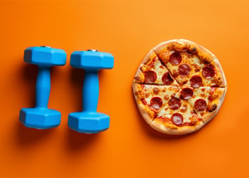Weights and pizza set against an orange background