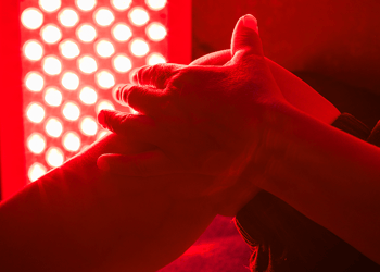 Persons sitting in a red light therapy room