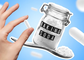 Hand holding a pill and a baking soda container in a blue background