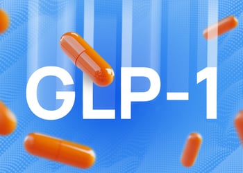 Orange GLP-1 booster pills falling in blue background