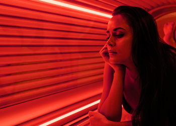 Person on a tanning bed with red light