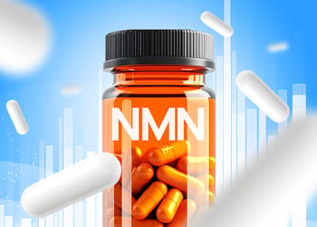 Transparent NMN bottle with pills and black cap, set against a blue background with splashing pills