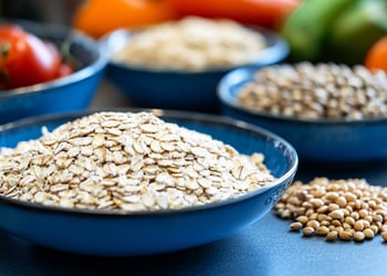 Bowls of different types of fiber, including vegetables and grains.