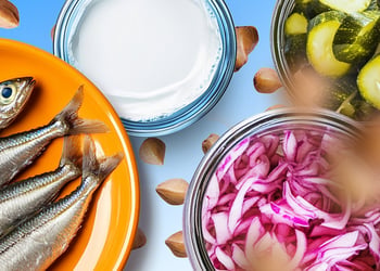 Herring, kefir, buckwheat and fermented vegetables on the blue background.