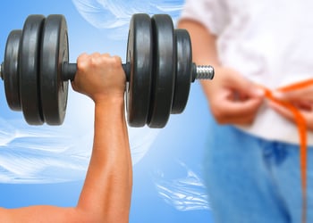 Arm holding a heavy dumbbell with person measuring waist in background