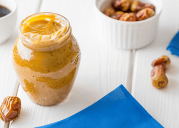 Date caramel recipe on a table set on a blue and white table