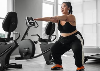 Person in the gym working out near sports equipment